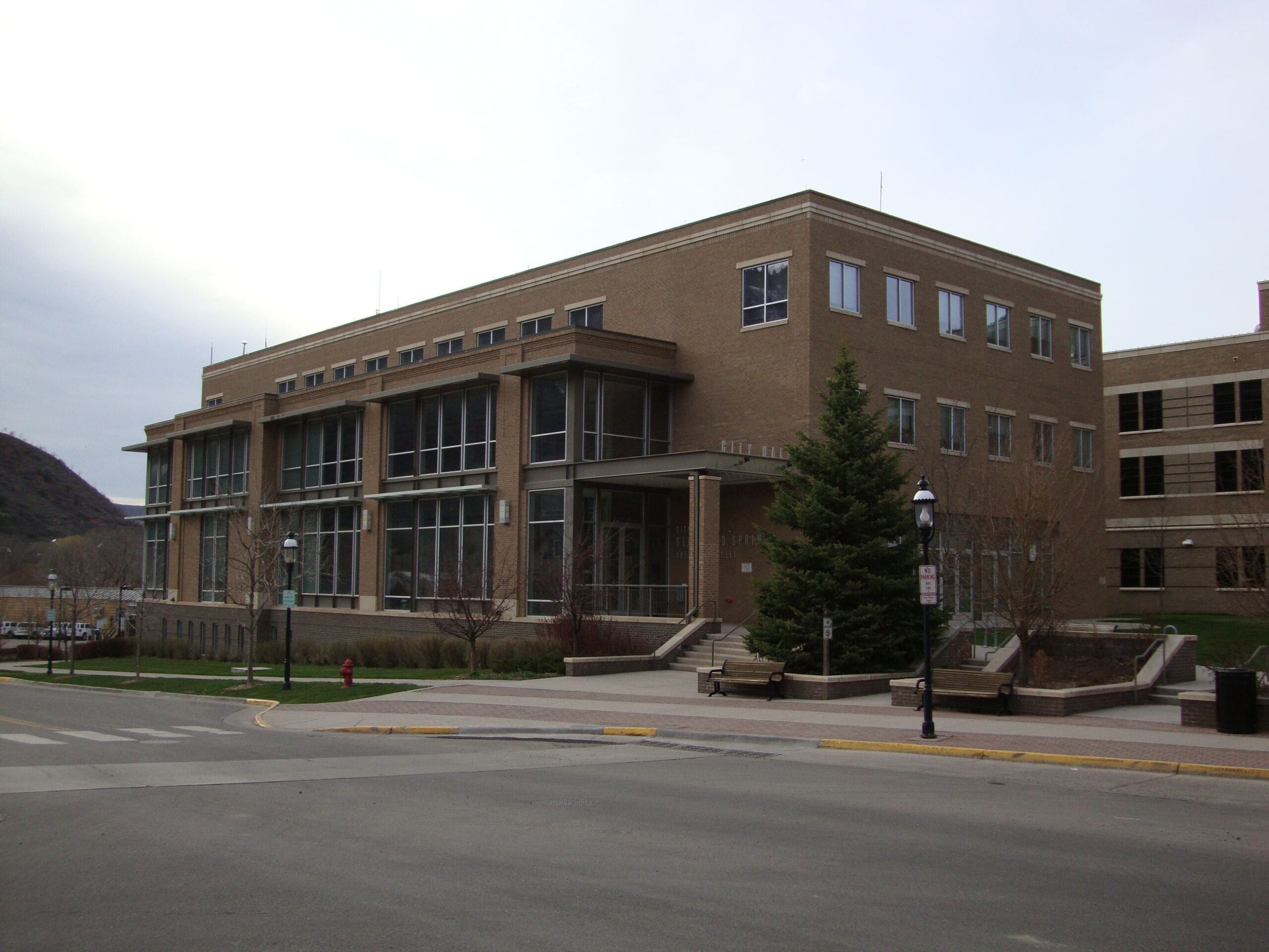 Wide angle view of a brown government building.